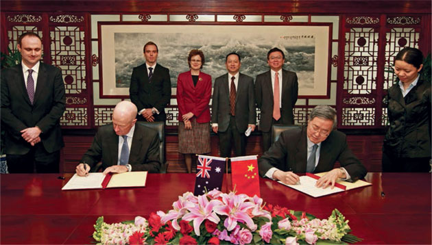 Governor Glenn Stevens and PBC Governor Zhou Xiaochuan signing the swap agreement at a ceremony in Beijing, in the presence of the RBA's representative in China, Ivan Roberts (far left) and the PBC's Lü Tingting (far right); behind them are the RBA's Mark Hack, Frances Adamson (Australia's Ambassador to China), Song Xiangyan, PBC Deputy Director-General, International Department, and Li Bo, PBC Director-General, Monetary Policy Department II