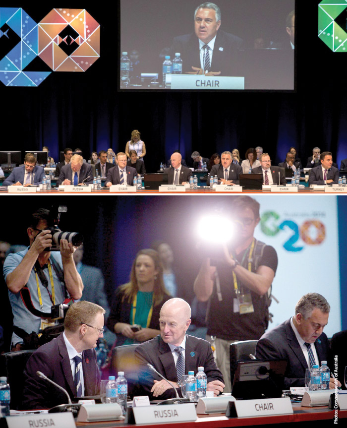 (Image above) The Australian Treasurer, the Hon Joe Hockey MP, chairing the G20 Meeting of Finance Ministers and Central Bank Governors, Cairns, September 2014 – the Treasurer is shown with Governor Glenn Stevens (centre), Deputy Governor Philip Lowe (also on his right), and Australia's G20 Finance Deputy, Barry Sterland PSM (on his left); (image below) the Governor and Deputy Governor conferring at the G20 meeting, with the Treasurer shown on the right (Photos: Commonwealth of Australia)