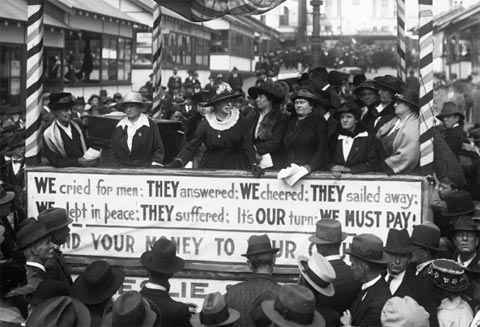 Australia needed to raise funds after the First World War to assist the returned troops. As part of Ladies Day, prominent women including Mrs Eleanor McKinnon, founder of the Junior Red Cross, spoke to the crowds in Martin Place for the second peace loan. Their placard refers to Villers-Bretonneux, a small village in the Somme in northern France, which was the site of a significant battle involving Australian troops during the First World War. Their sacrifice is still remembered in the village with an Australian National Memorial, a ceremony on Anzac Day and a school known as the Victoria School.