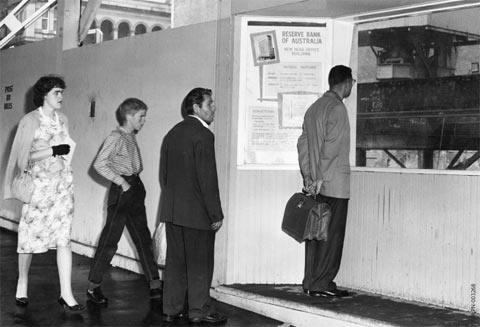 Passers-by stop to look at the construction of the new Reserve Bank of Australia Head Office, December 1961. At the time that the Reserve Bank building was constructed, Martin Place was still open to traffic. Plans to convert it to a pedestrian plaza began in the early 1970s with the whole of the thoroughfare converted by 1979.