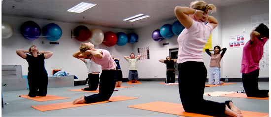 Photograph of a yoga class taking place at the fitness facility at Head Office.