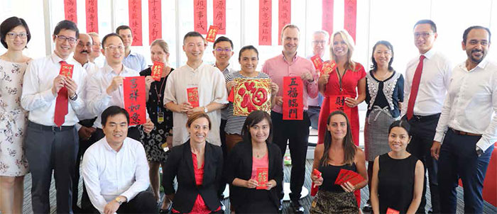 Bank staff celebrating the Lunar New Year with a special themed lunch and traditional Chinese calligraphy keepsakes