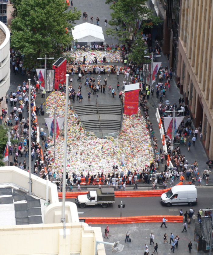 The multitude of flowers laid in Martin Place in the days following the siege at the Lindt Café on 15 December 2014 reflected the outpouring of grief and sympathy in the community of Sydney. The Governor laid flowers on behalf of the Reserve Bank in the week following the siege. This photograph was taken from Level 3 of the Bank's Head Office building, directly across the road from the Lindt Café, on 19 December.