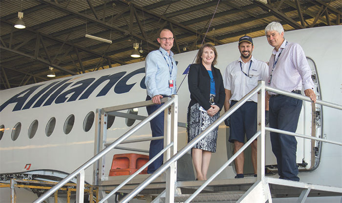 Alliance Aviation Services CEO Lee Schofield (left) with Senior Representative, Queensland Office, Karen Hooper, Alliance staff member Jonathan Evans and Alliance Managing Director Scott McMillan (right) in the company's maintenance hanger, February 2016