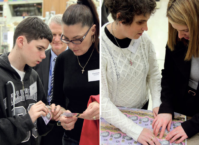 Members of the vision-impaired community learn about the tactile feature on the new $5 banknote at the preview event, June 2016