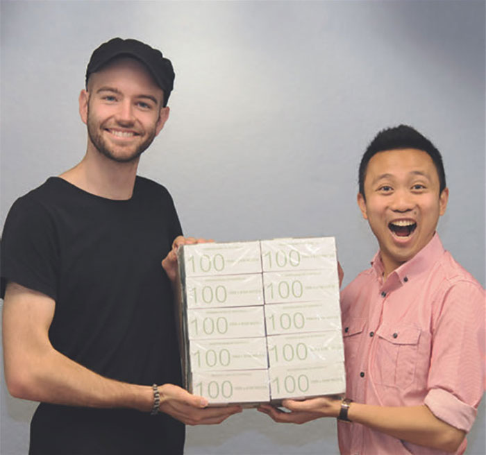 Reserve Bank staff Tobias Beckmann and Josef Manalo hold $1 million during the annual Sydney Open, November 2015