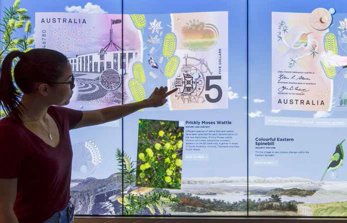 (Top) Dung Nguyen from Note Issue Department conducts a presentation on the new $5 banknote at the multi-touch screen display in the Reserve Bank of Australia Museum during Sydney Open, November 2016; (above) Reserve Bank staff explore the multi-touch screen display in the museum, September 2016