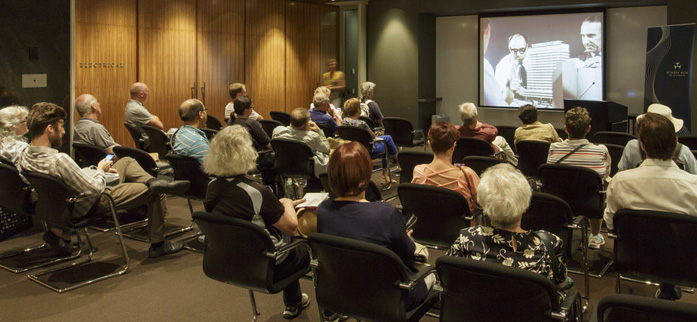 (Top) The Head Office foyer during Sydney Open, November 2016; (above) Sydney Open visitors watch 'Planned for Progress', a film depicting the construction of the Reserve Bank's Head Office building, November 2016