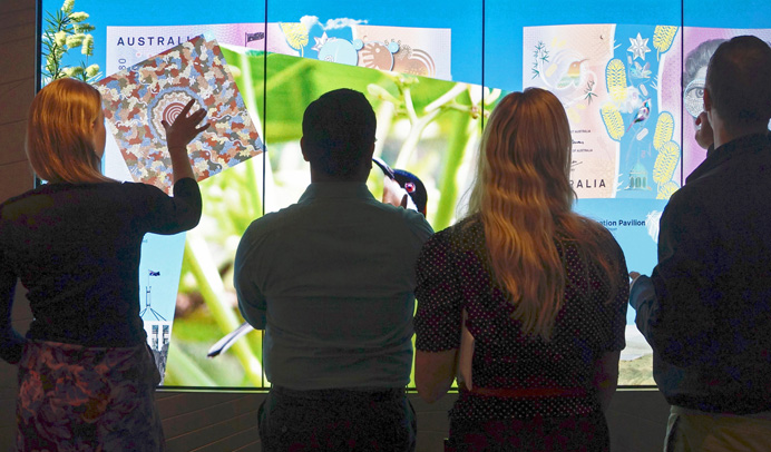 (Top) Dung Nguyen from Note Issue Department conducts a presentation on the new $5 banknote at the multi-touch screen display in the Reserve Bank of Australia Museum during Sydney Open, November 2016; (above) Reserve Bank staff explore the multi-touch screen display in the museum, September 2016