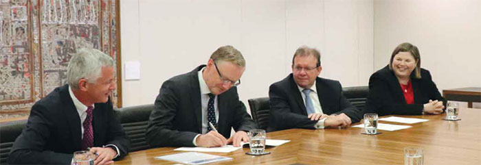 Governor Philip Lowe (second from left) signs the Reserve Bank's Financial Statements in the presence of the Auditor-General for Australia Grant Hehir (third from left), Carla Jago, Group Executive Director, Assurance Audit Services Group, Australian National Audit Office (right) and Reserve Bank Chief Financial Officer Robert Middleton-Jones (left)