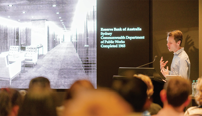 Curator Guy Betts talks to visitors during Sydney Open about the architecture and design of Reserve Bank's Head Office building, November 2019