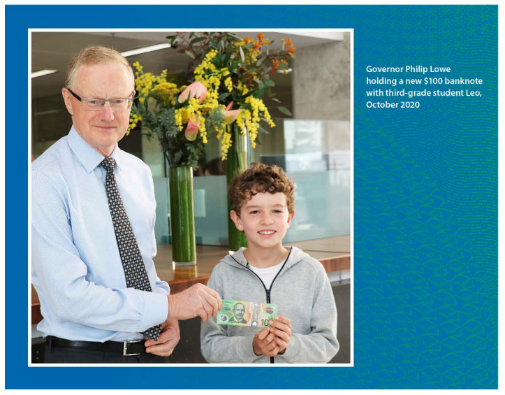 Governor Philip Lowe holding a new $100 banknote with third-grade student Leo, October 2020