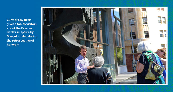 Curator Guy Betts gives a talk to visitors about the Reserve Bank's sculpture by Margel Hinder, during the retrospective of her work