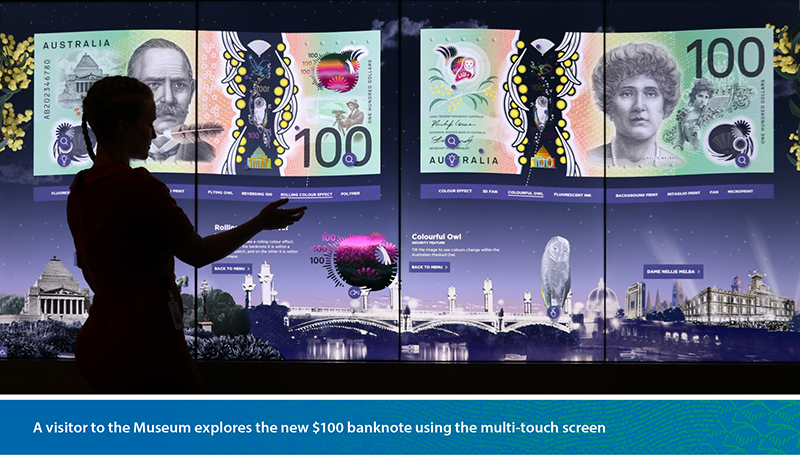 A visitor to the Museum explores the new $100 banknote using the multi-touch screen