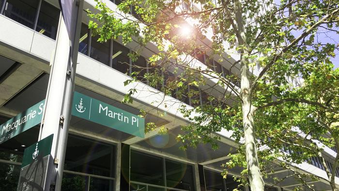 A photograph of a Martin Place street sign in front of the Reserve Bank Head Office