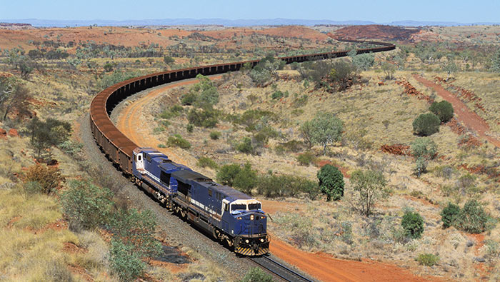 A long mining train snakes its way through dry country