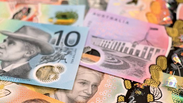 Various new Australian banknotes are laid out, with the ten-dollar banknote being prominent.