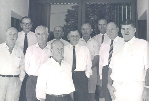 Reserve Bank Board members outside the Darwin branch, June 1968, from left to right: William Pettingell (later Sir); Henry Rowden; John Phillips (later Sir); Sir Leslie Melville; Dr H C Coombs; Sir Richard Randall; Sir Theo Kelly; Harry Knight (later Sir) as an observer; Donald Hibberd (later Sir); Sir William Gunn. <br><br> <small>RBA Archives PN-004723</small>